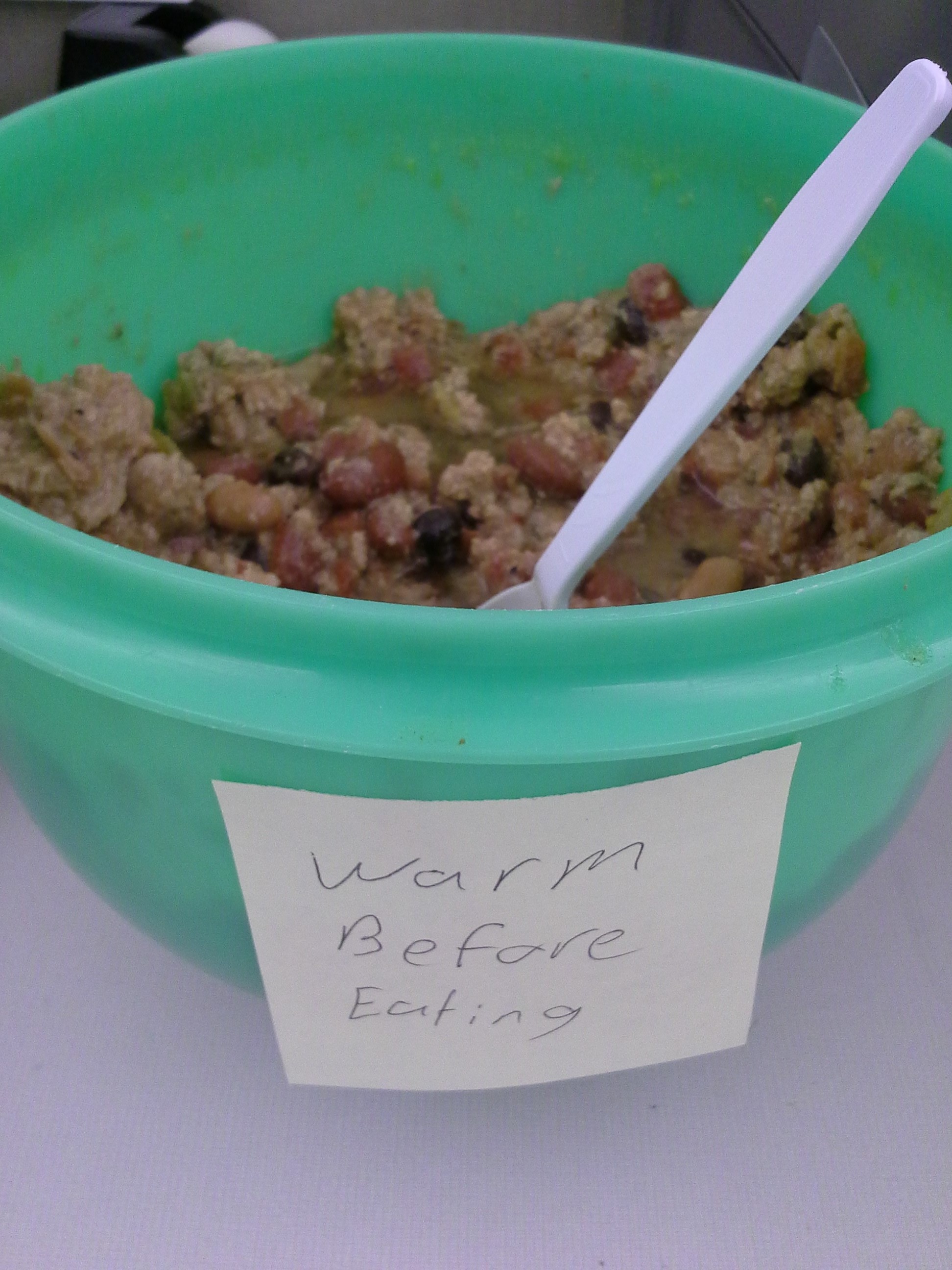 bright green bowl full of beans and meat chunks or something. looks like a food nightmare